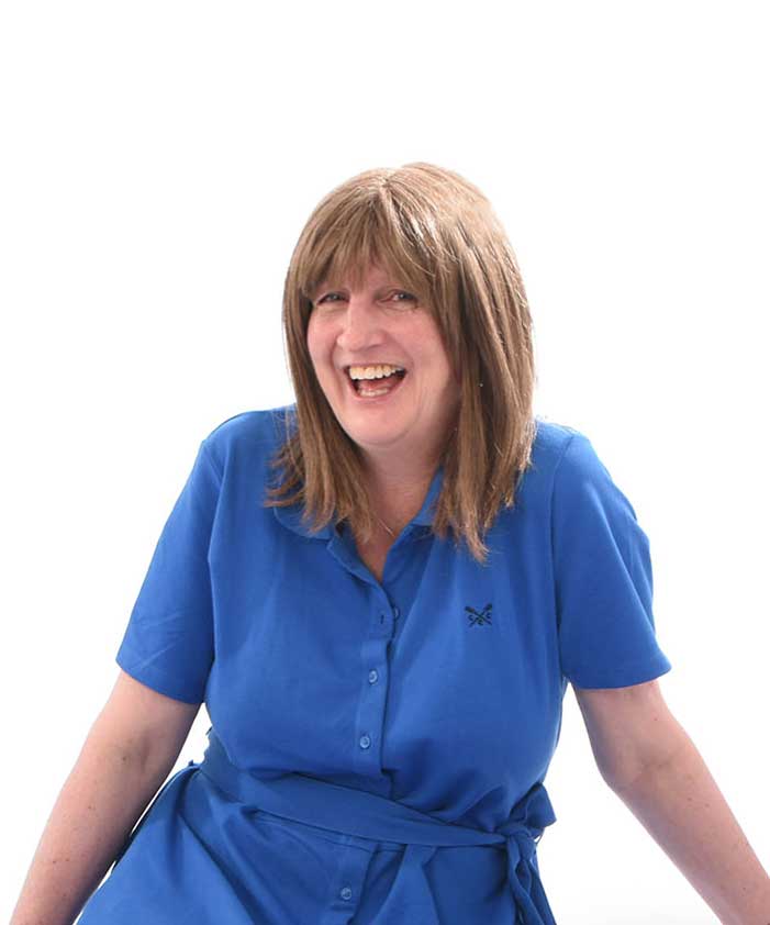 Nina laughing in blue dress sitting on the white background