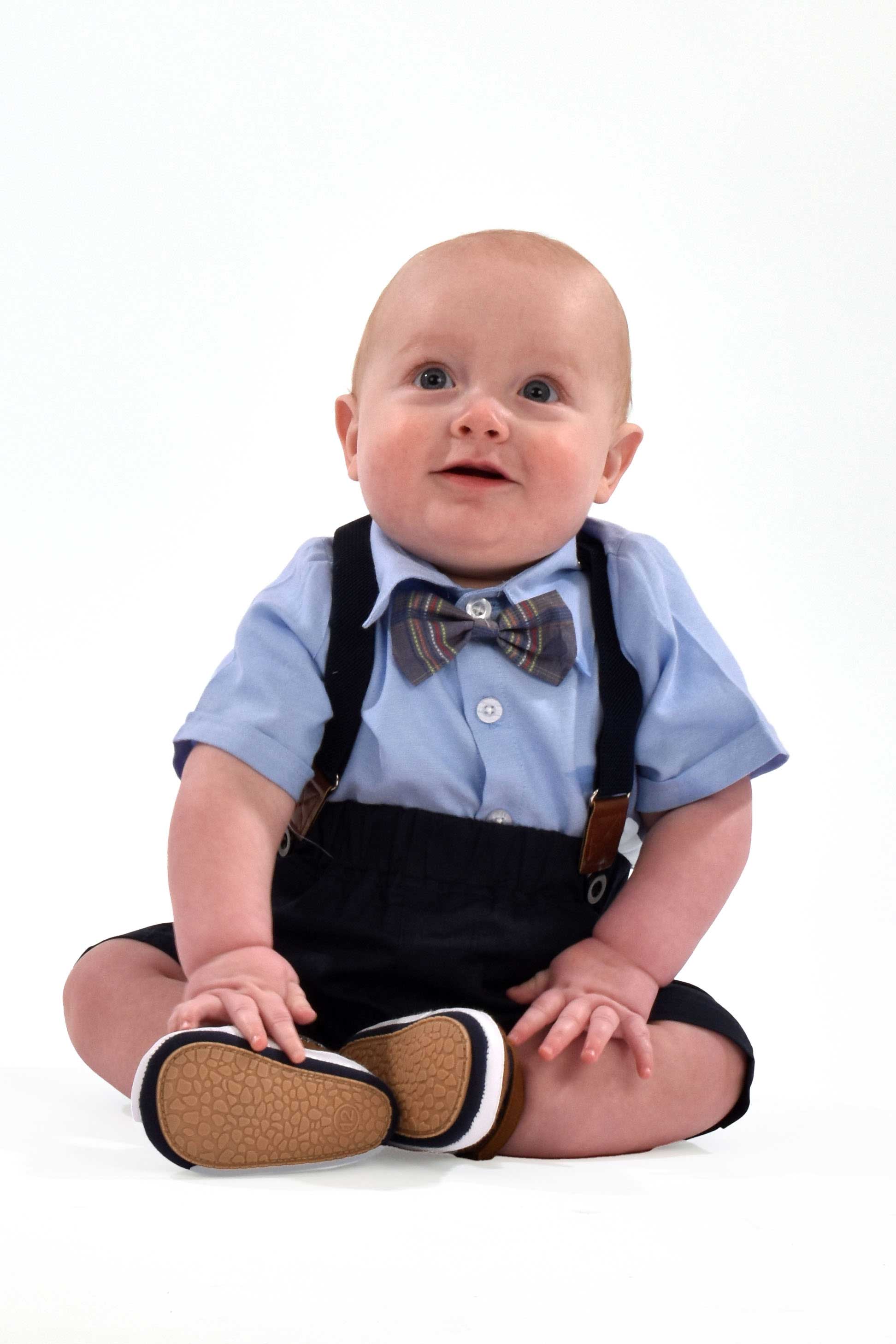 baby Archer under 1 in fancy dress sitting on white background looking slightly up